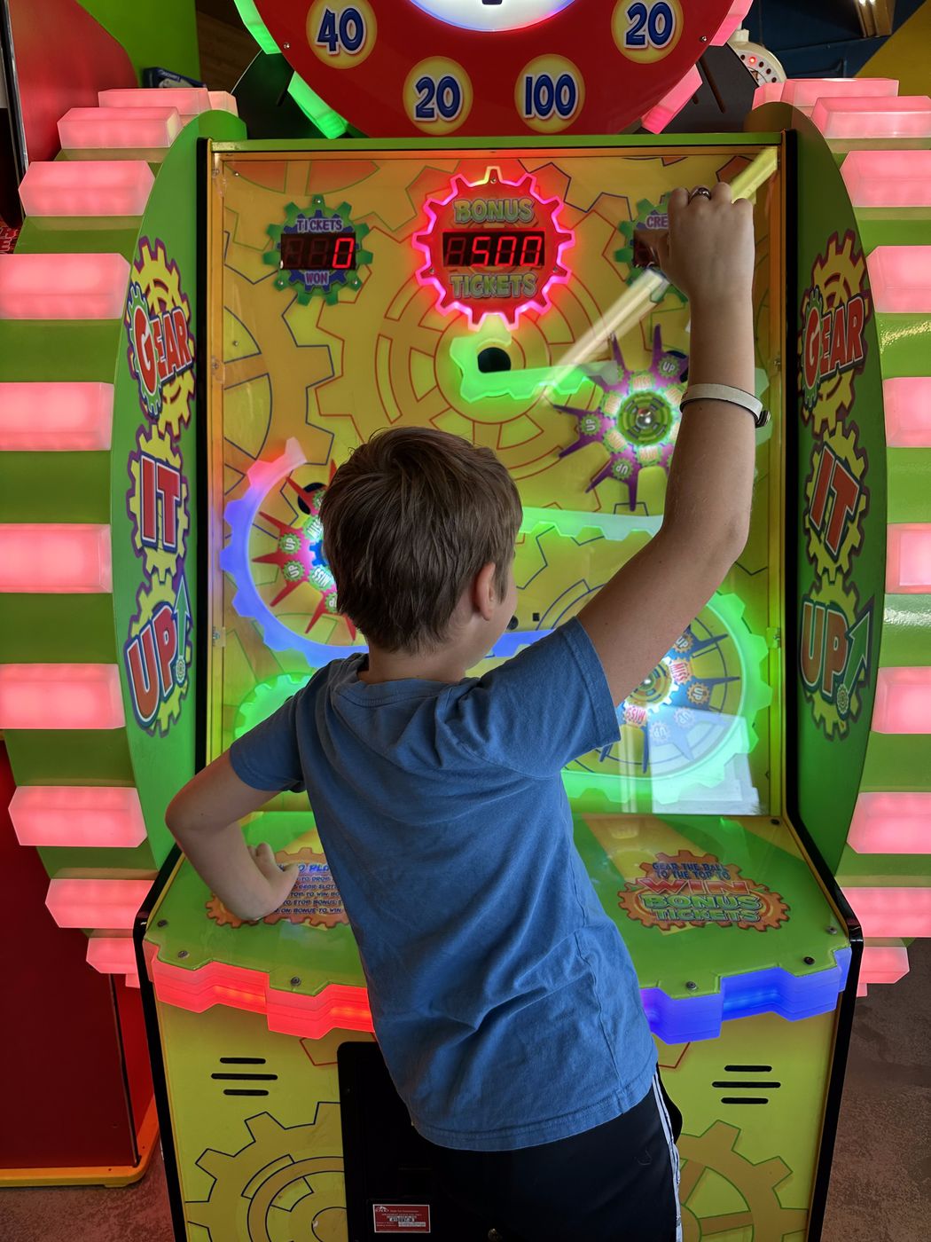 Kid playing the Gear It Up ticket arcade game at Glow Games Twin Falls