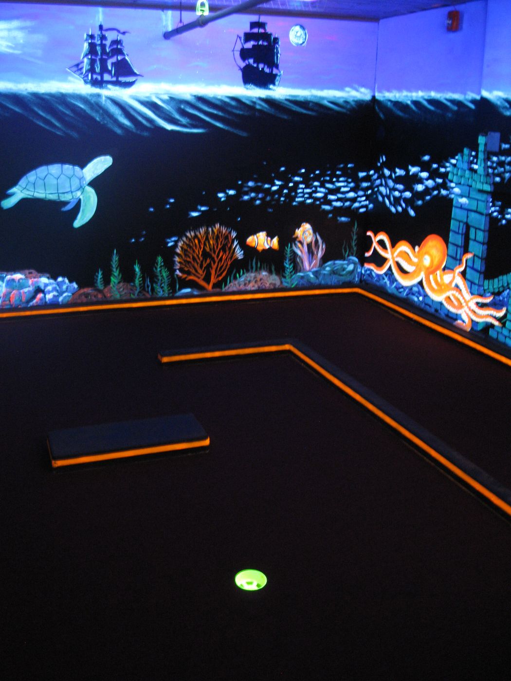Under-the-sea blacklit mini golf hole at Glow Games Twin Falls